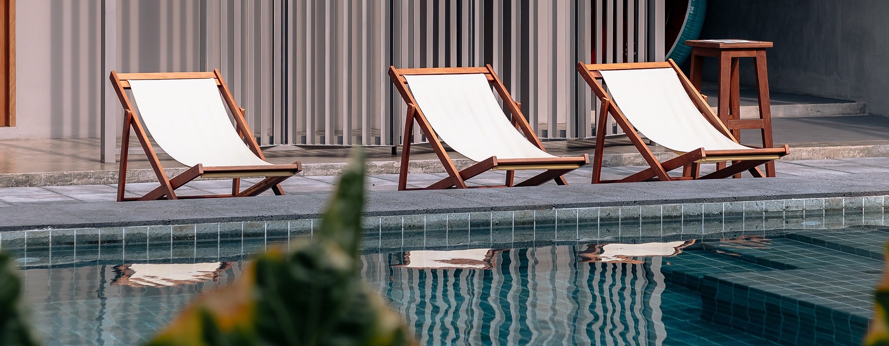 lifestyle image of rows of chairs by the pool
